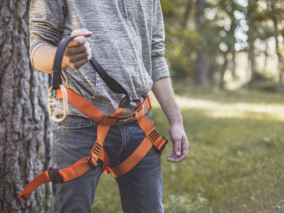 Man wearing harness with lanyard and carabiner